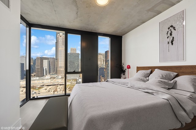 234 West Polk Street, Unit 2610 Chicago, IL 60605 - Photo 10 of 36 a bedroom with a large bed and a large window with outer view