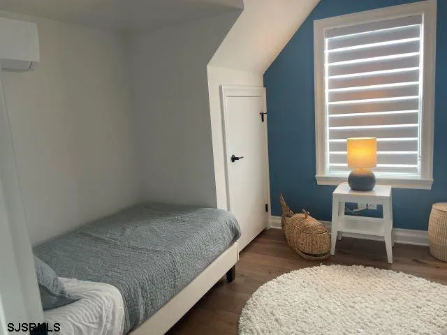 a bedroom with a bed and chair