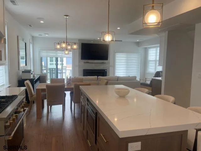 a large kitchen with a table and chairs