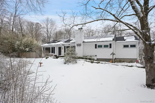 a view of a house with snow on the road