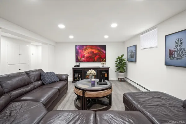 a living room with furniture a rug and a flat screen tv