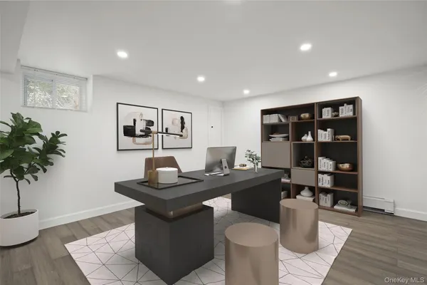 a view of a workspace with furniture and wooden floor