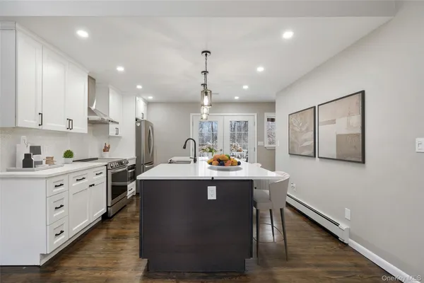 a kitchen with counter top space cabinets and stainless steel appliances