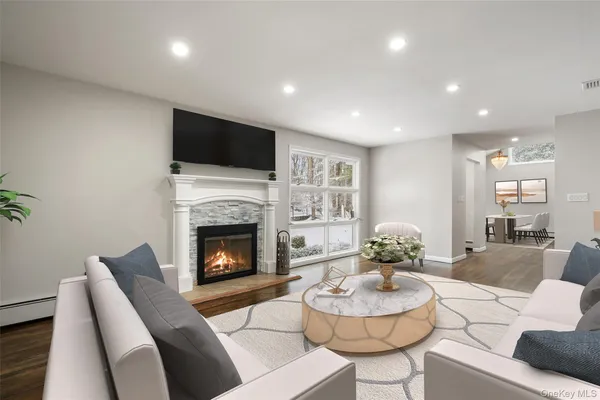 a living room with furniture and a fireplace