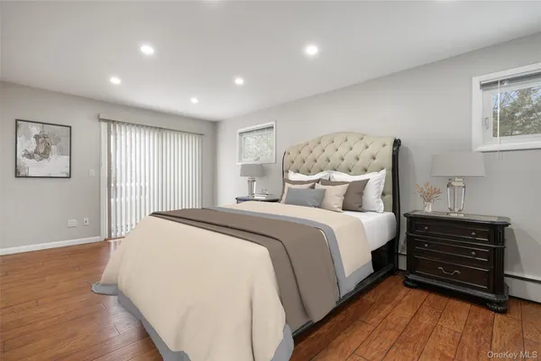 a spacious bedroom with a bed and a dresser