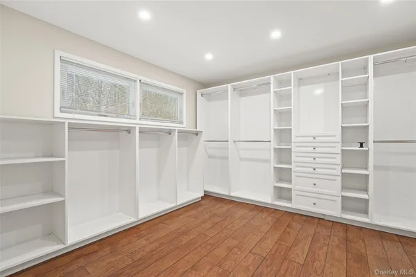 a view of walk in closet with empty racks