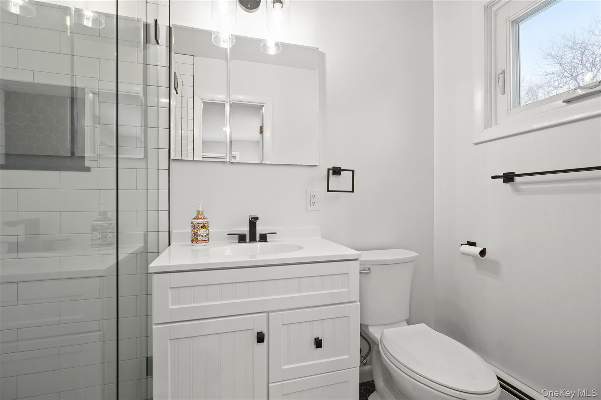 59 Hoags Cross Road Ossining, NY 10562 - Photo 10 of 25 a bathroom with a sink a toilet and vanity