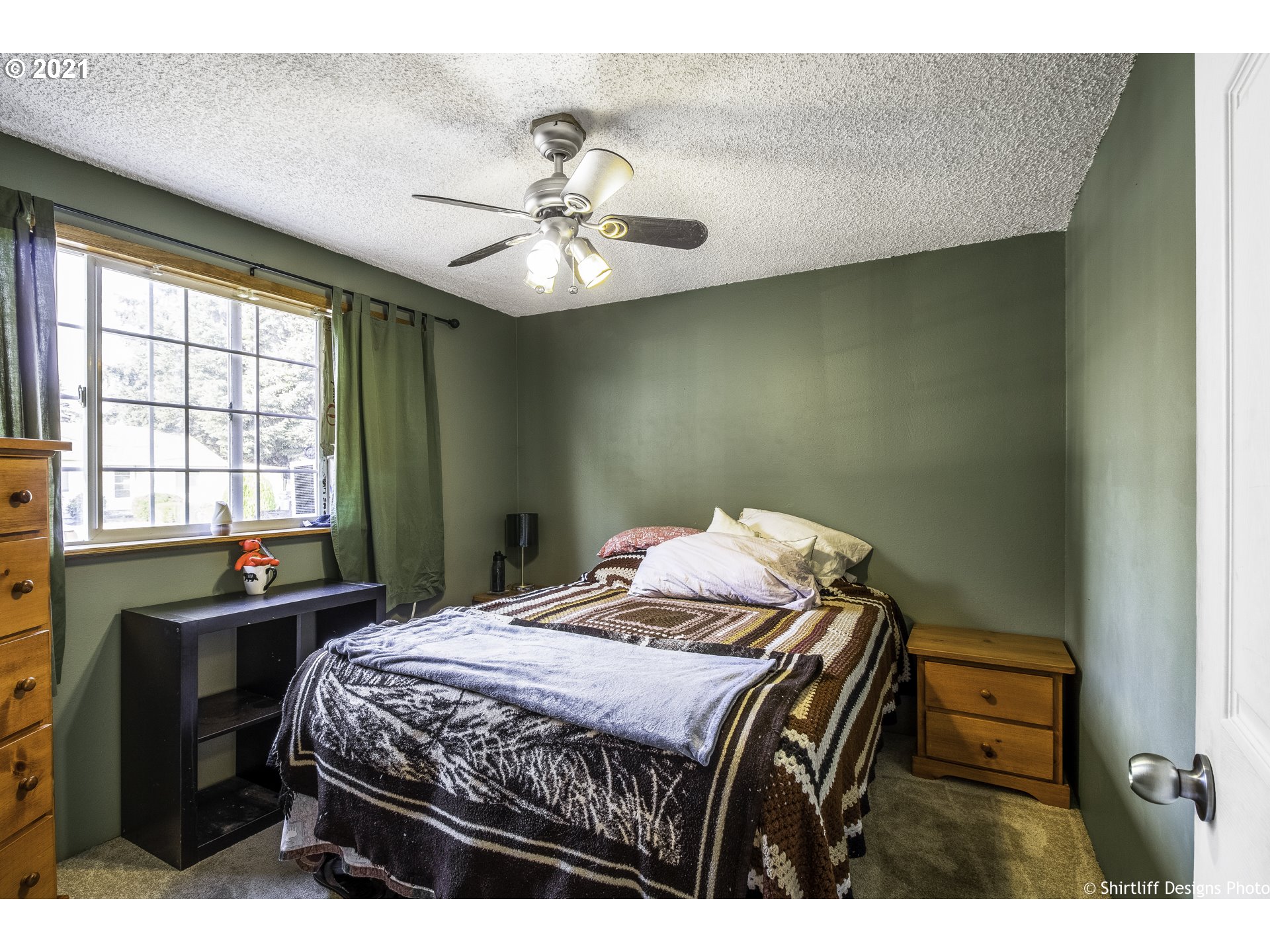 5181 D Street Springfield, OR 97478 - Photo 13 of 16 a bedroom with a bed and a chandelier