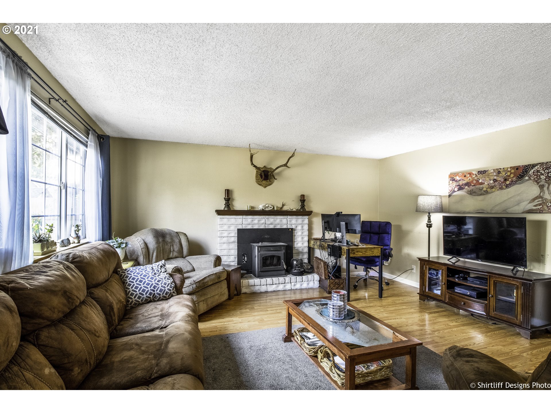 5181 D Street Springfield, OR 97478 - Photo 3 of 16 a living room with furniture a flat screen tv and a fireplace
