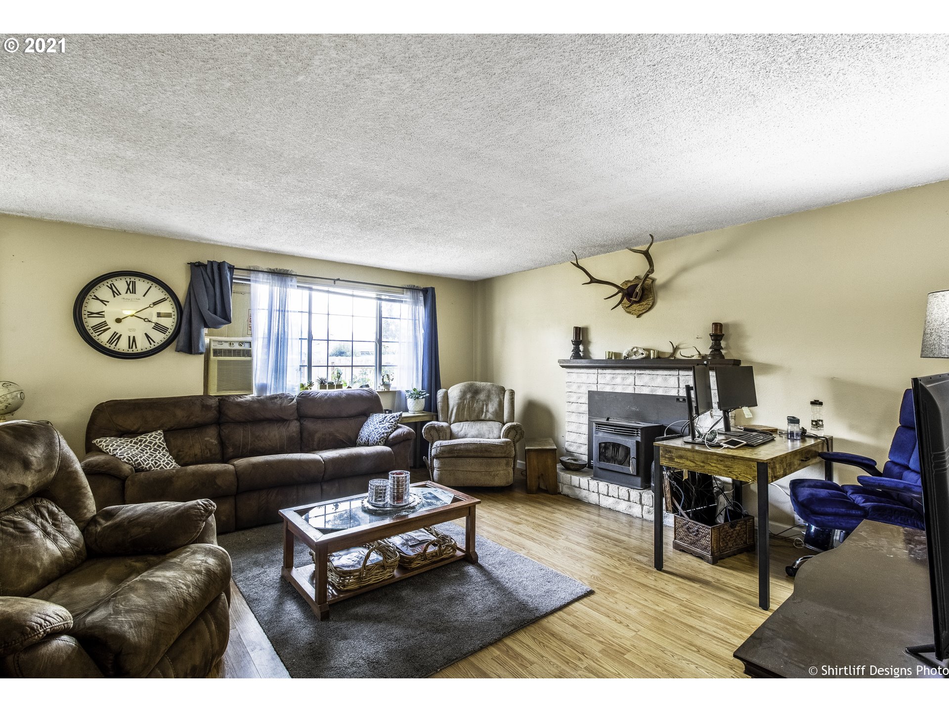 5181 D Street Springfield, OR 97478 - Photo 4 of 16 a living room with furniture a clock on wall and a window