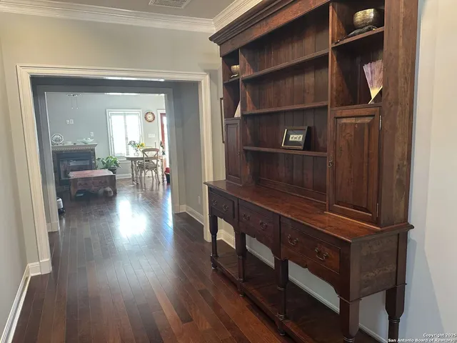a living room with wooden floor and furniture