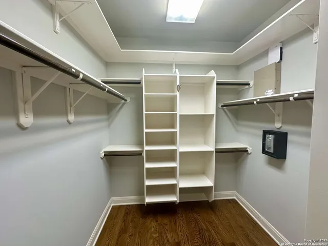 a view of walk in closet with empty racks