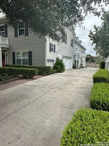 a front view of a house with a yard and a garage