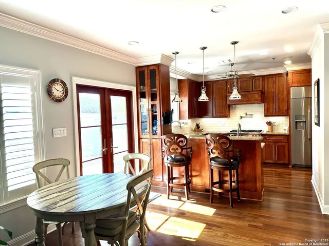 a view of a dining room with furniture and chandelier