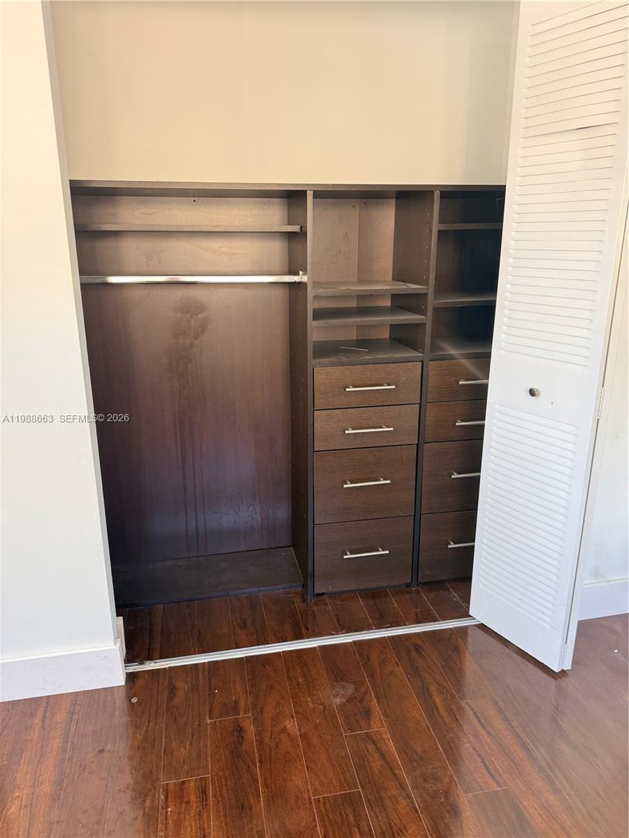 14343 Southwest 98th Terrace Miami, FL 33186 - Photo 12 of 16 a view of walk in closet with wooden floor