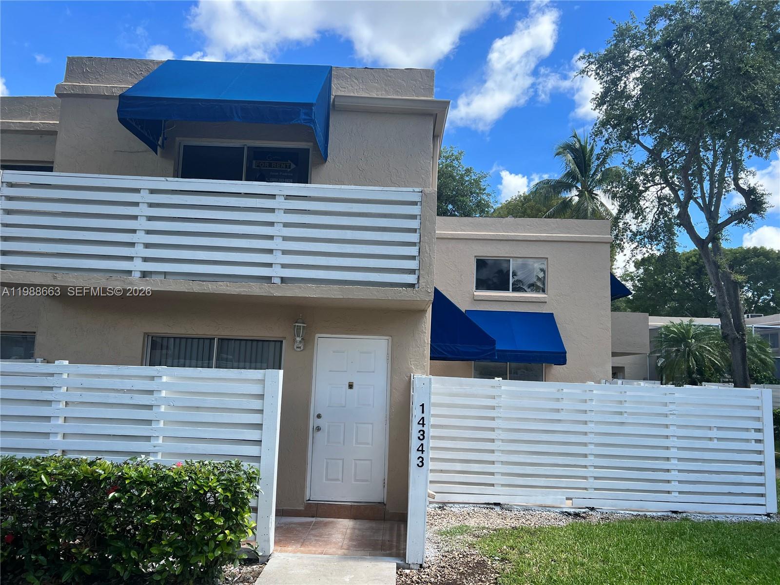 14343 Southwest 98th Terrace Miami, FL 33186 - Photo 2 of 16 a view of a white house with a small yard and large tree