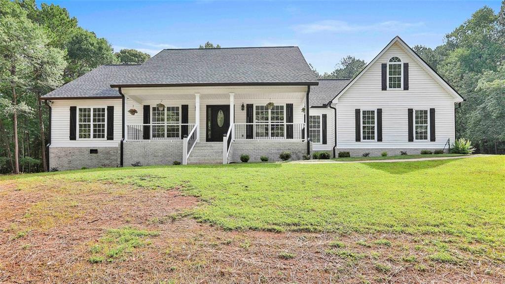 187 Doc Perry Road Newnan, GA 30263 - Photo 1 of 1 a front view of a house with garden