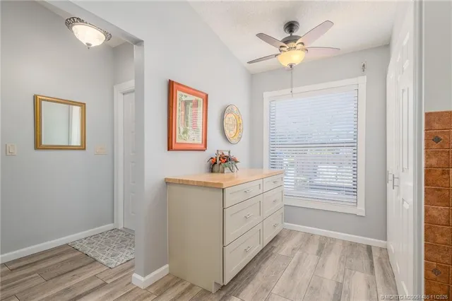 a view of kitchen with cabinets and window