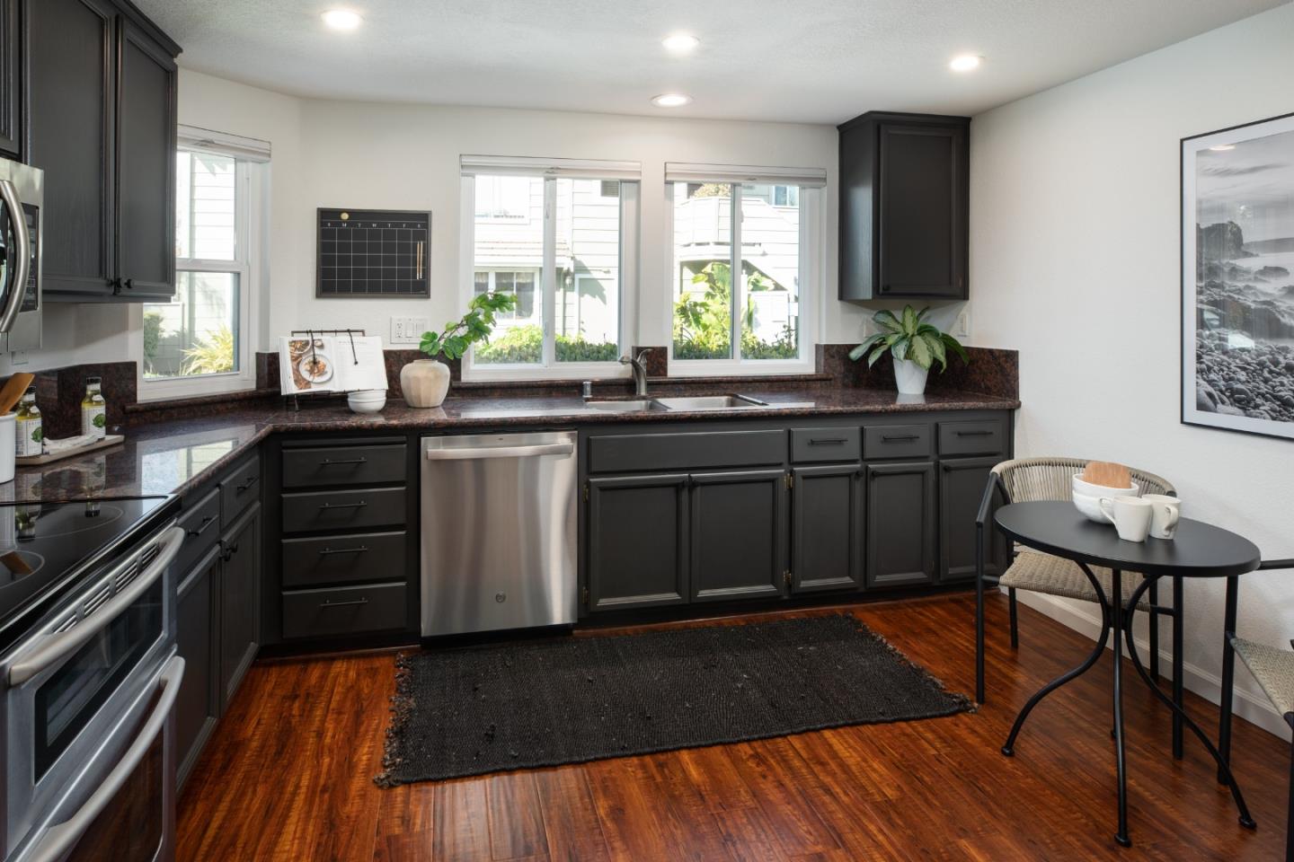 40 Cherryton Lane San Jose, CA 95136 - Photo 12 of 27 a kitchen with stainless steel appliances granite countertop wooden cabinets a stove top oven a sink and dishwasher
