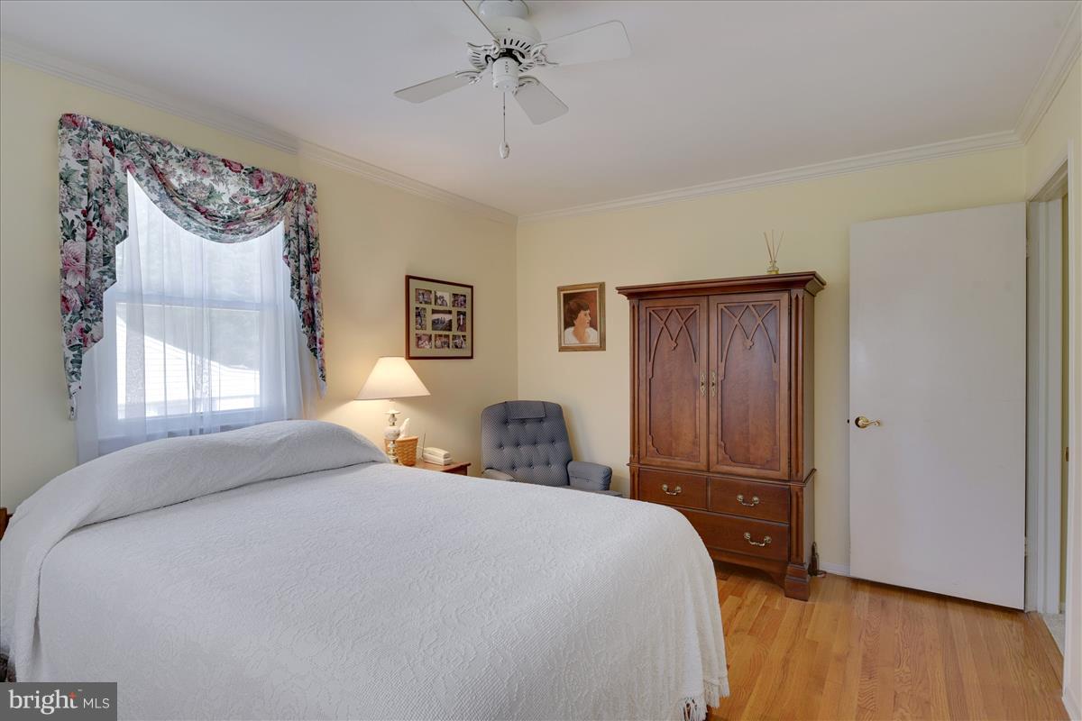 7516 Inzer Street Springfield, VA 22151 - Photo 15 of 30 a bedroom with a bed and wooden floor