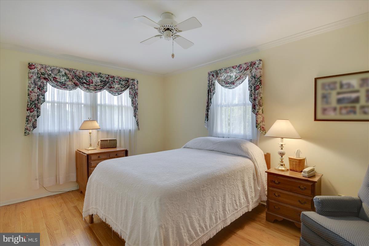7516 Inzer Street Springfield, VA 22151 - Photo 16 of 30 a bedroom with a bed and wooden floor