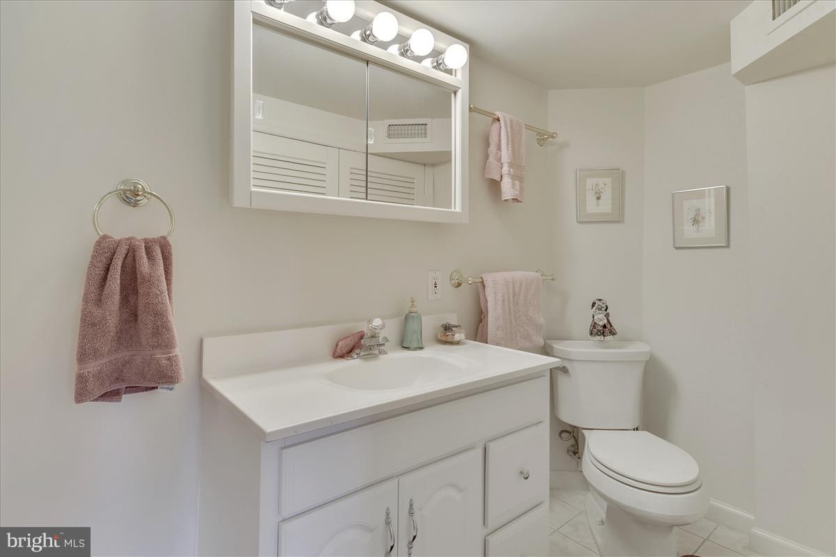 7516 Inzer Street Springfield, VA 22151 - Photo 24 of 30 a bathroom with a toilet sink and mirror