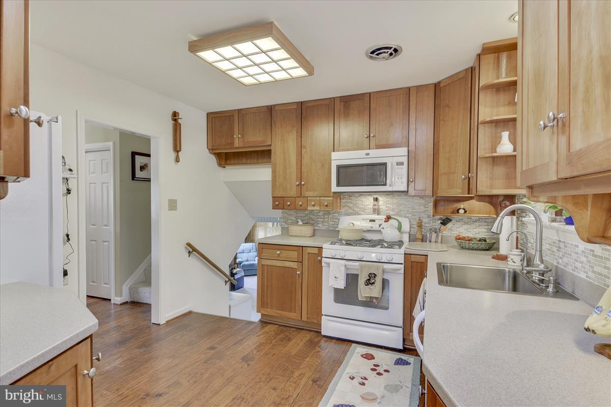 7516 Inzer Street Springfield, VA 22151 - Photo 3 of 30 a kitchen with stainless steel appliances granite countertop a sink stove and refrigerator
