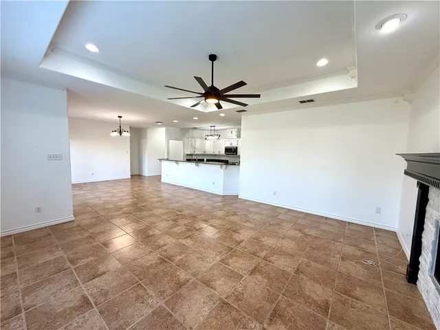 a view of a kitchen with a sink and a ceiling fan