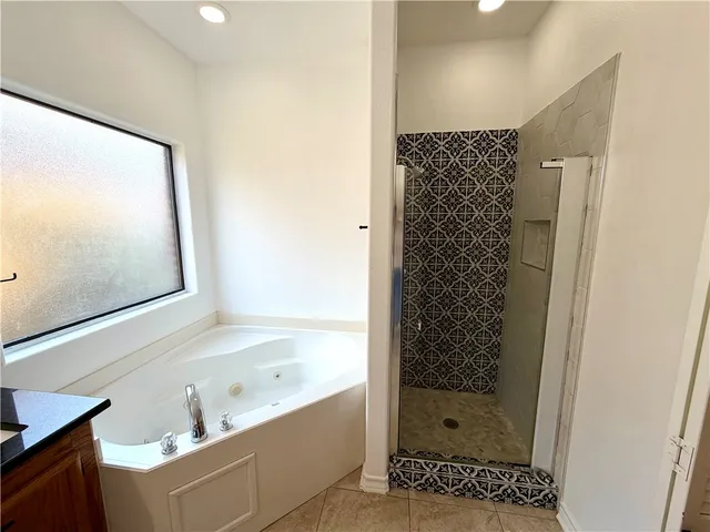 a bathroom with a bathtub and a shower