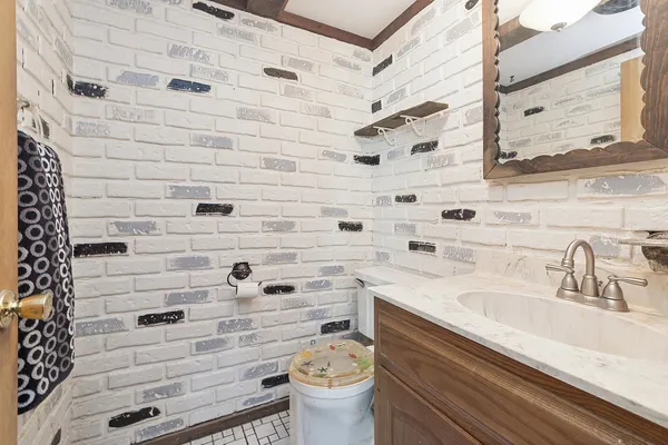 a bathroom with a sink a toilet and shower curtain