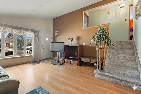 a view of a livingroom with couch and a potted plant