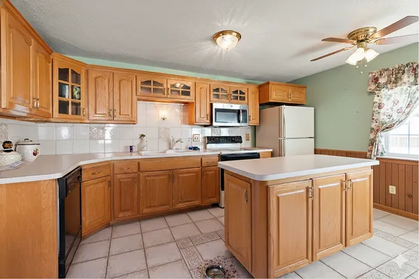 a kitchen with a sink cabinets and window