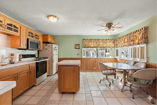 a kitchen with furniture a refrigerator and a sink