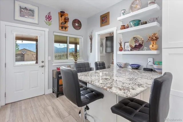 a view of a dining room with furniture and a potted plant