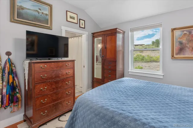 a bedroom with a bed and a television