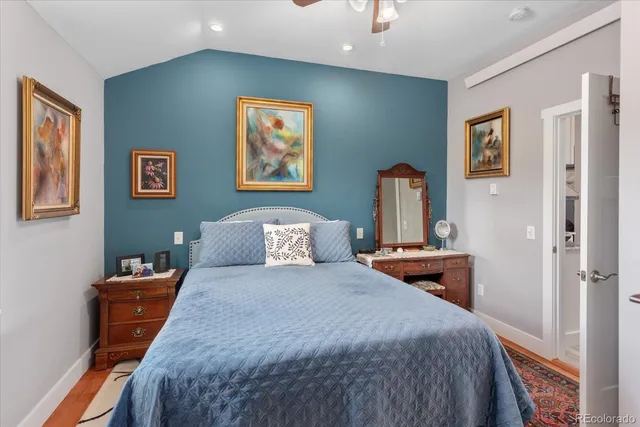 a bedroom with bed and wall painting