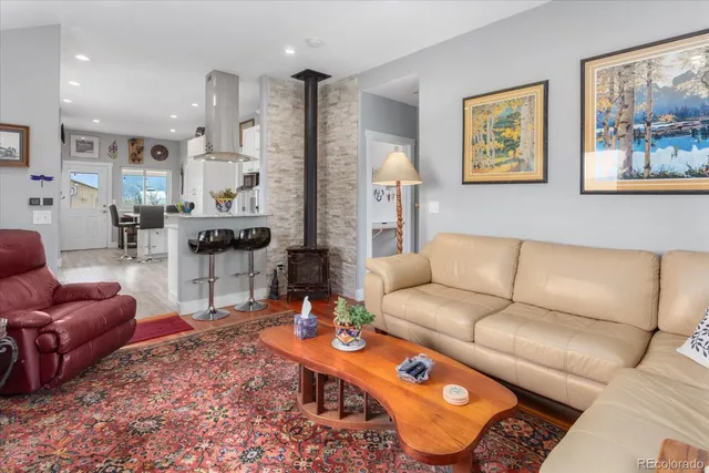 a living room with furniture and a view of kitchen