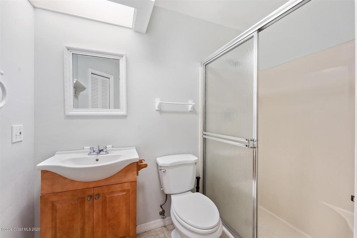 3600 Leghorn Road Grant Valkaria, FL 32950 - Photo 14 of 33 a bathroom with a sink a toilet and shower