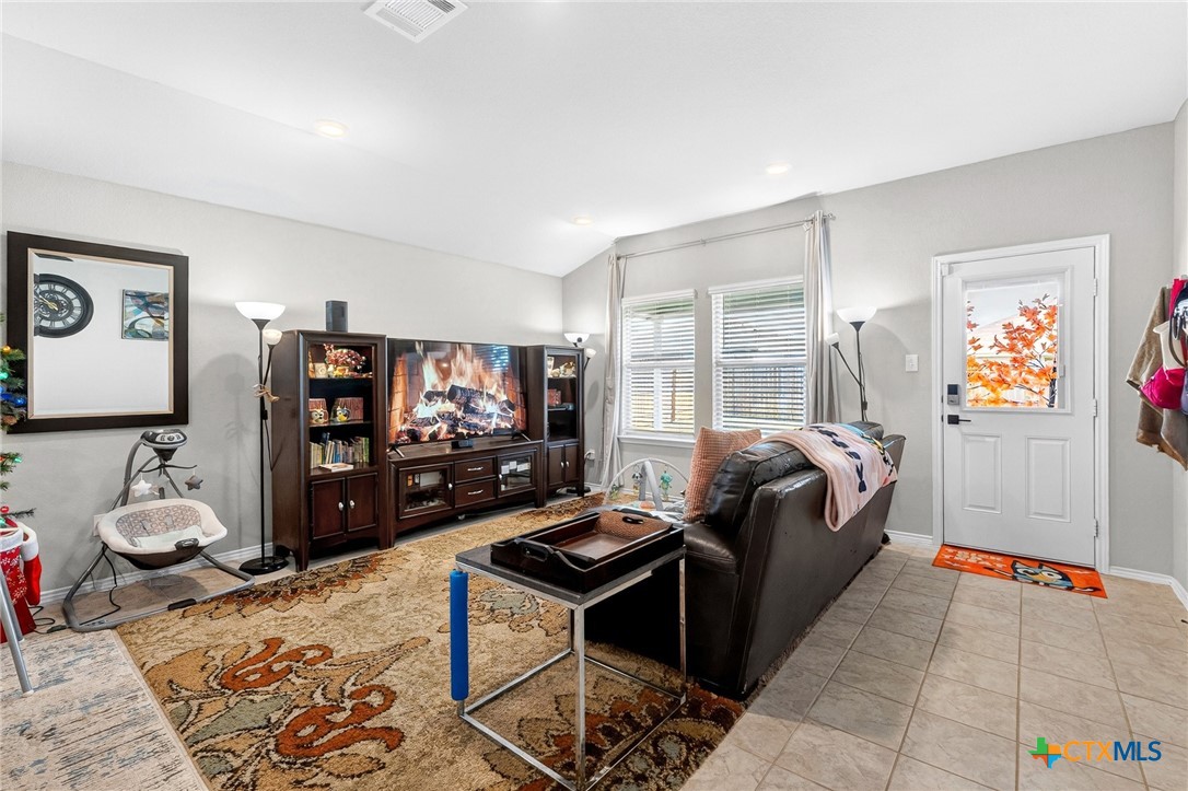 5102 Vivien Street Killeen, TX 76549 - Photo 5 of 23 a living room with furniture a flat screen tv and a window
