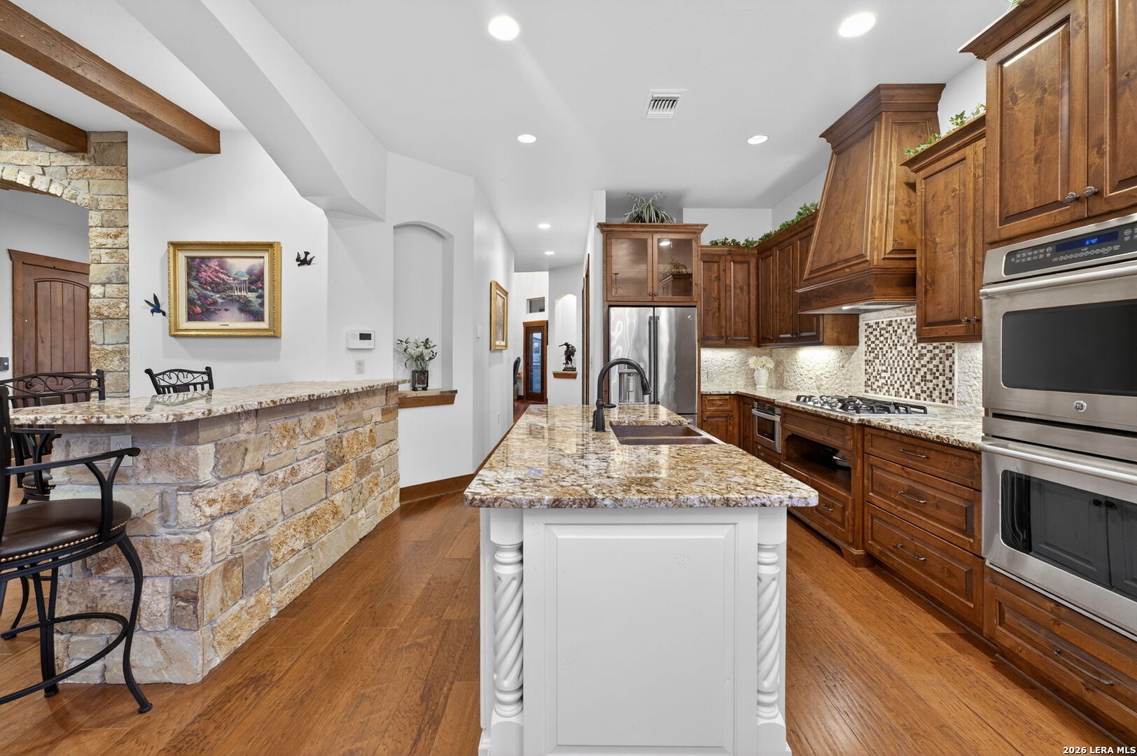 134 Bandit Beach Road New Braunfels, TX 78130 - Photo 13 of 77 a kitchen with stainless steel appliances granite countertop a lot of counter space and wooden floors