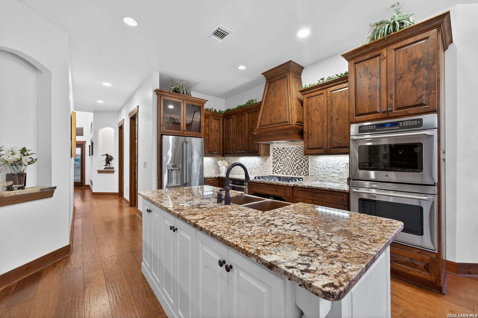 134 Bandit Beach Road New Braunfels, TX 78130 - Photo 15 of 77 a kitchen with stainless steel appliances granite countertop a sink refrigerator and cabinets