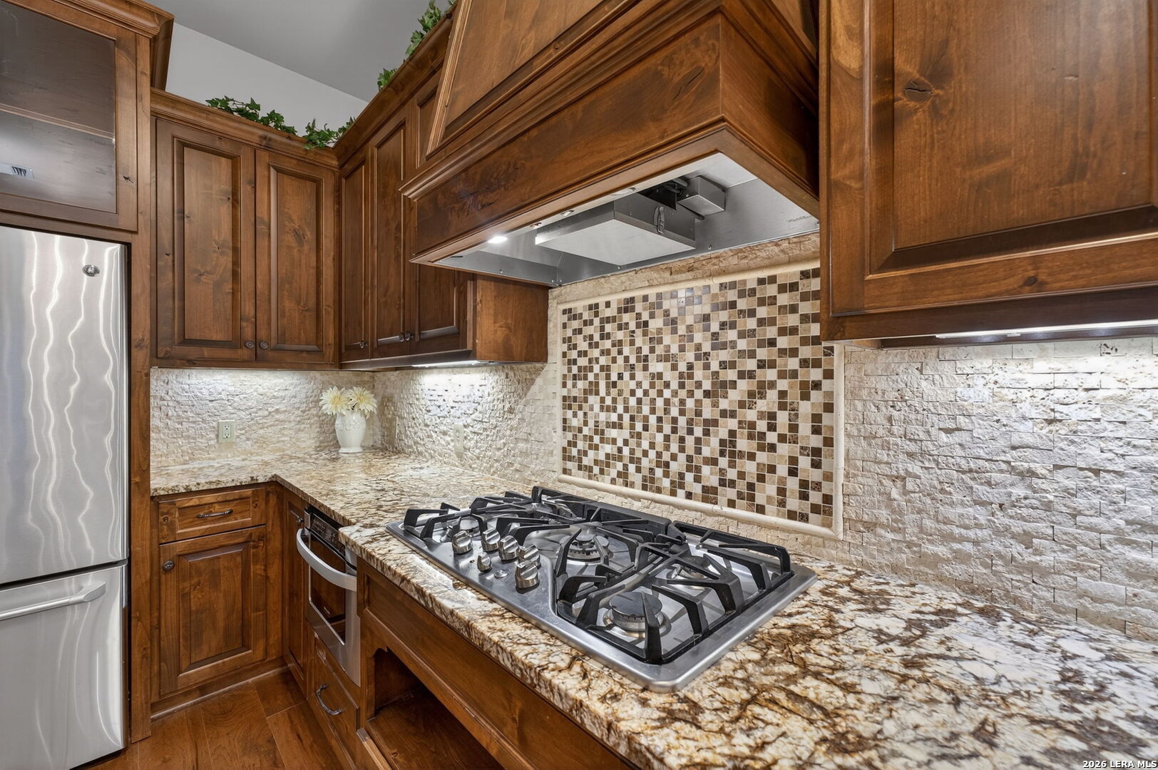 134 Bandit Beach Road New Braunfels, TX 78130 - Photo 16 of 77 a kitchen with wooden cabinets and a stove top oven