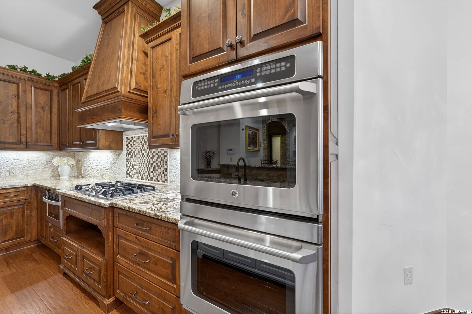 134 Bandit Beach Road New Braunfels, TX 78130 - Photo 17 of 77 a kitchen with granite countertop stainless steel appliances and white cabinets