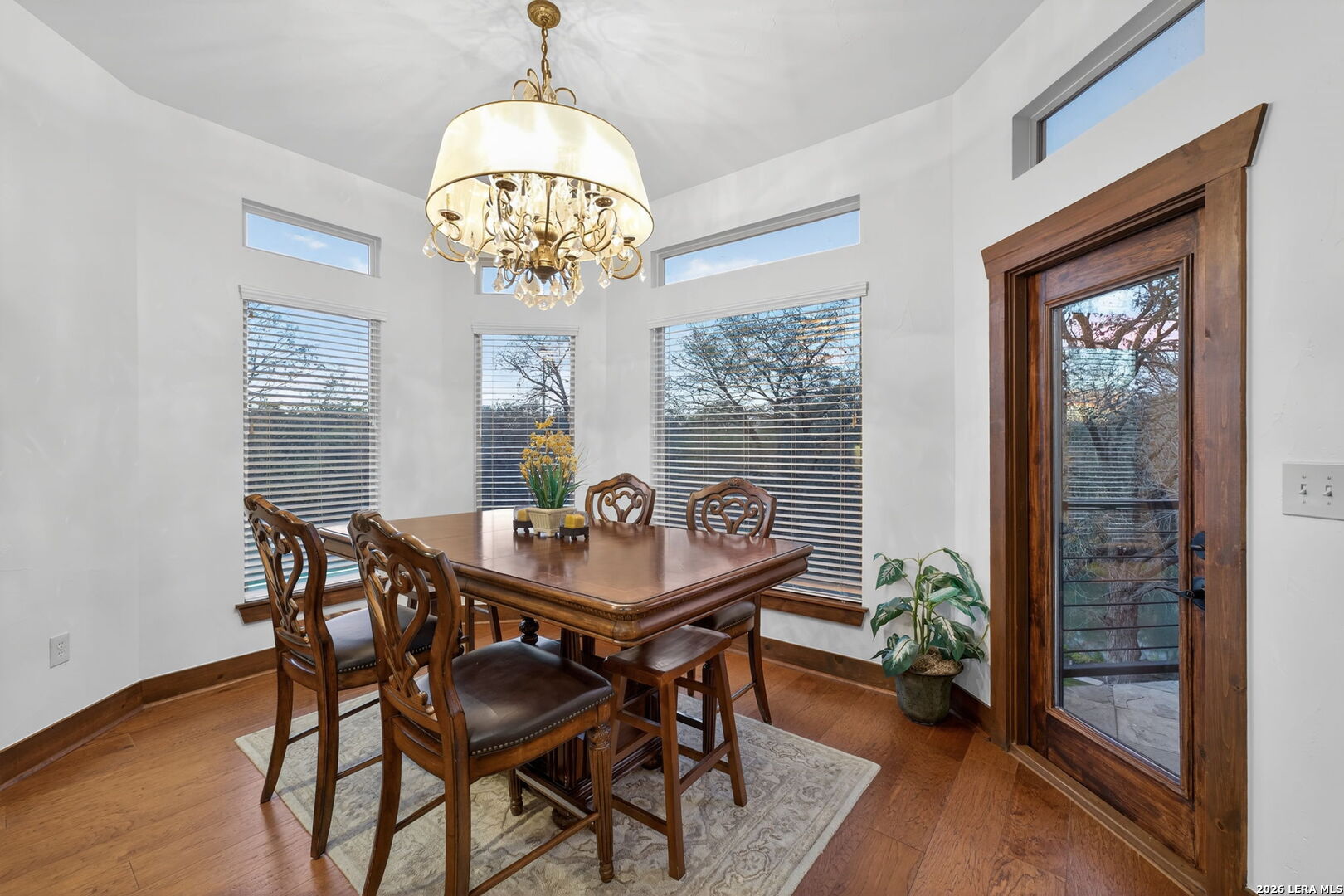 134 Bandit Beach Road New Braunfels, TX 78130 - Photo 19 of 77 a view of a dining room with furniture a chandelier and wooden floor