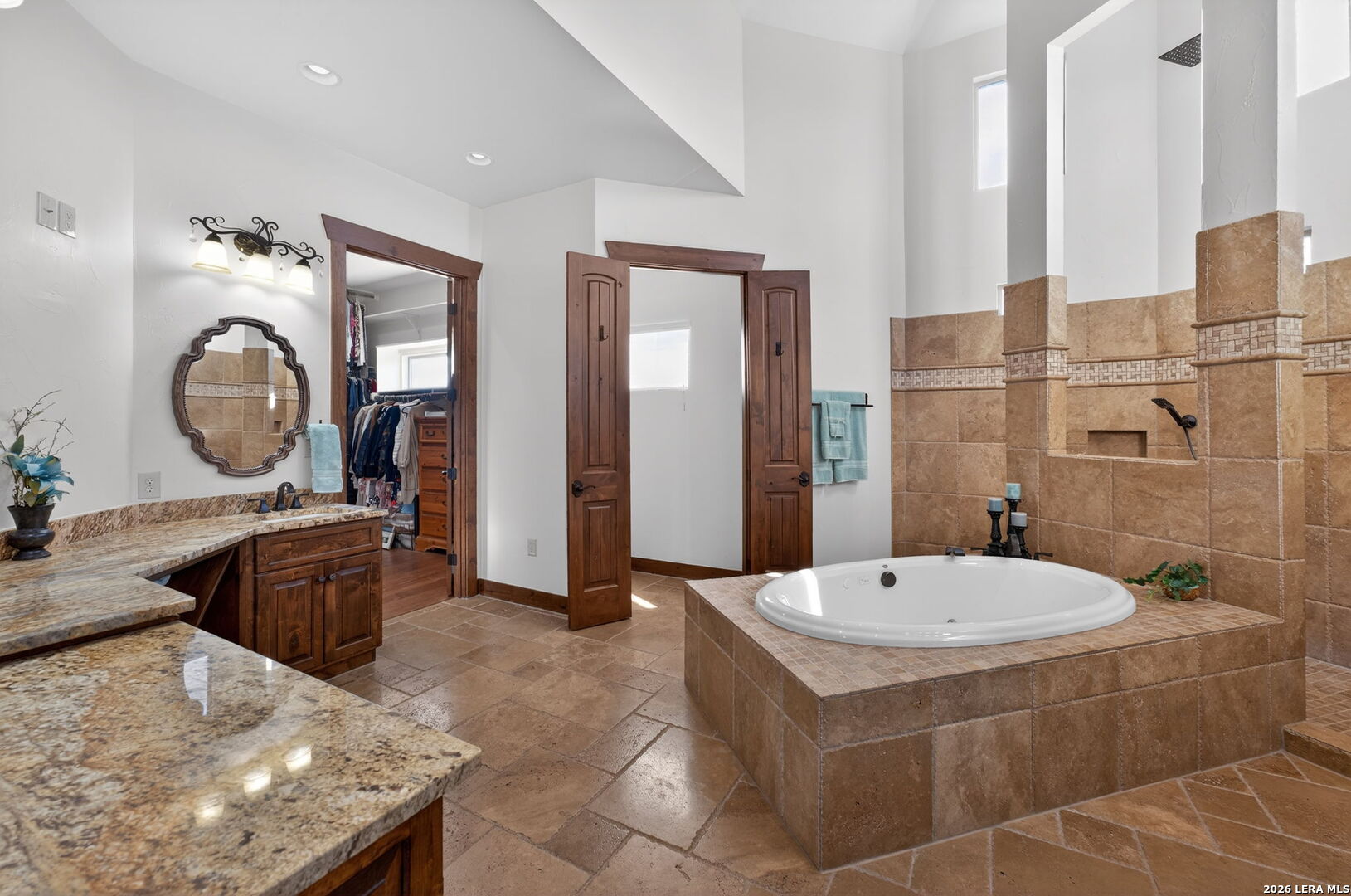 134 Bandit Beach Road New Braunfels, TX 78130 - Photo 43 of 77 a bathroom with a tub a sink and a mirror