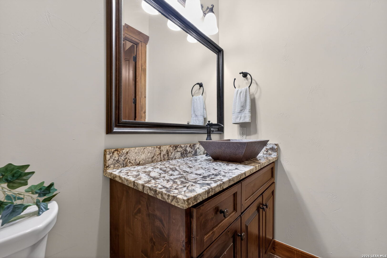 134 Bandit Beach Road New Braunfels, TX 78130 - Photo 59 of 77 a bathroom with a granite countertop sink and a mirror