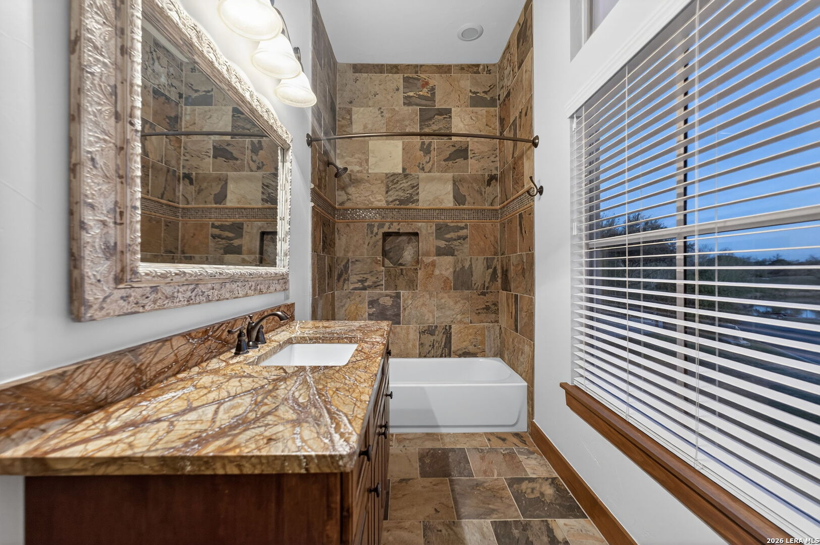134 Bandit Beach Road New Braunfels, TX 78130 - Photo 61 of 77 a bathroom with a granite countertop sink a toilet and shower