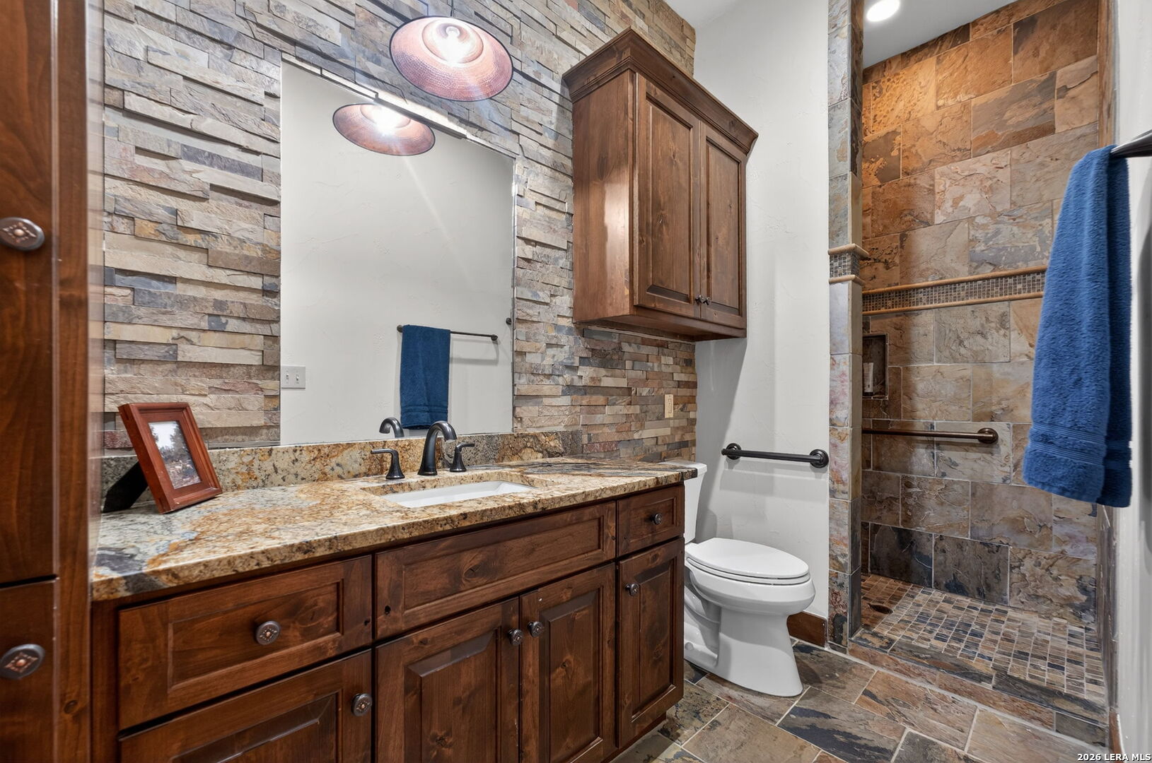 134 Bandit Beach Road New Braunfels, TX 78130 - Photo 62 of 77 a bathroom with a granite countertop sink toilet and shower