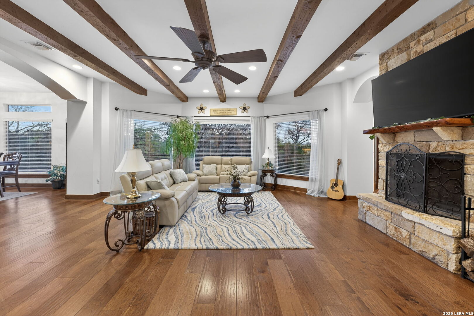 134 Bandit Beach Road New Braunfels, TX 78130 - Photo 8 of 77 a living room with furniture a flat screen tv and a fireplace