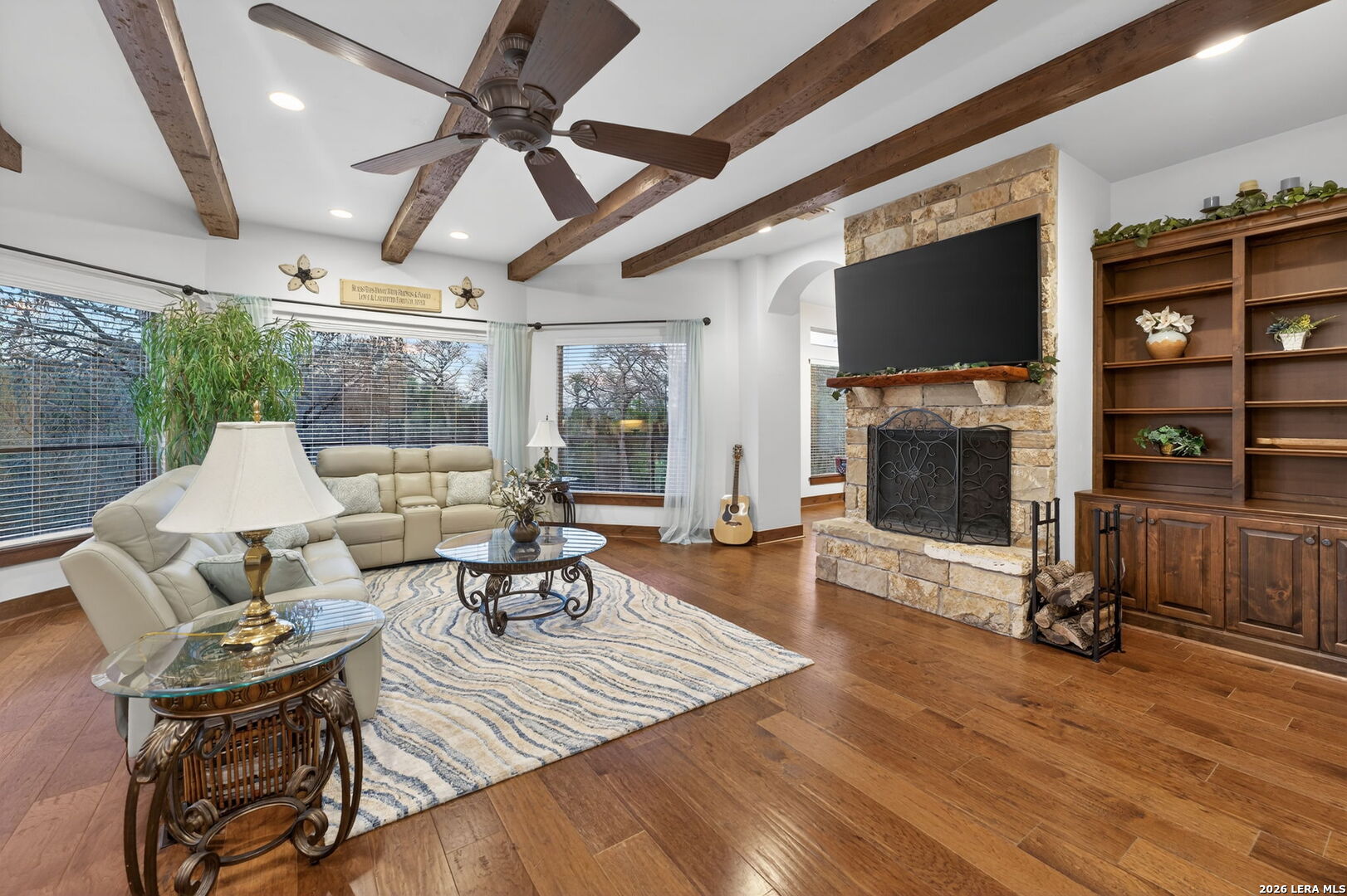 134 Bandit Beach Road New Braunfels, TX 78130 - Photo 9 of 77 a living room with furniture a flat screen tv and a fireplace
